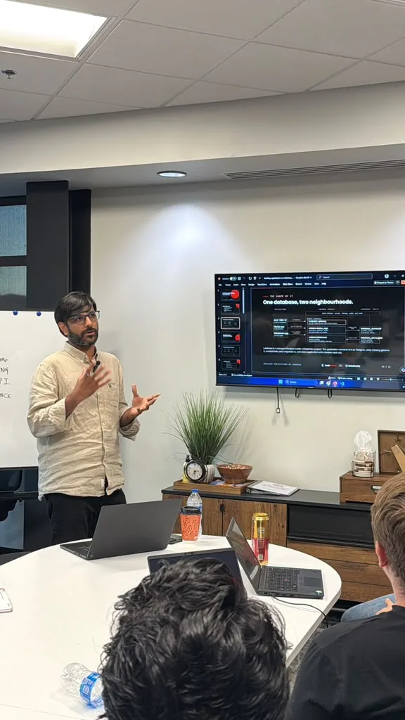 A presenter talking through the slide titled One database, two neighbourhoods, which sets the Lakebase project beside Unity Catalog.