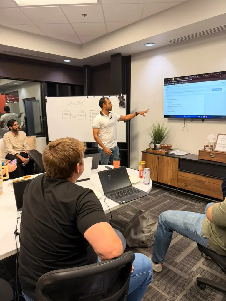A presenter at the screen putting a question to the data, with the whiteboard listing scale to zero, branching and data API.